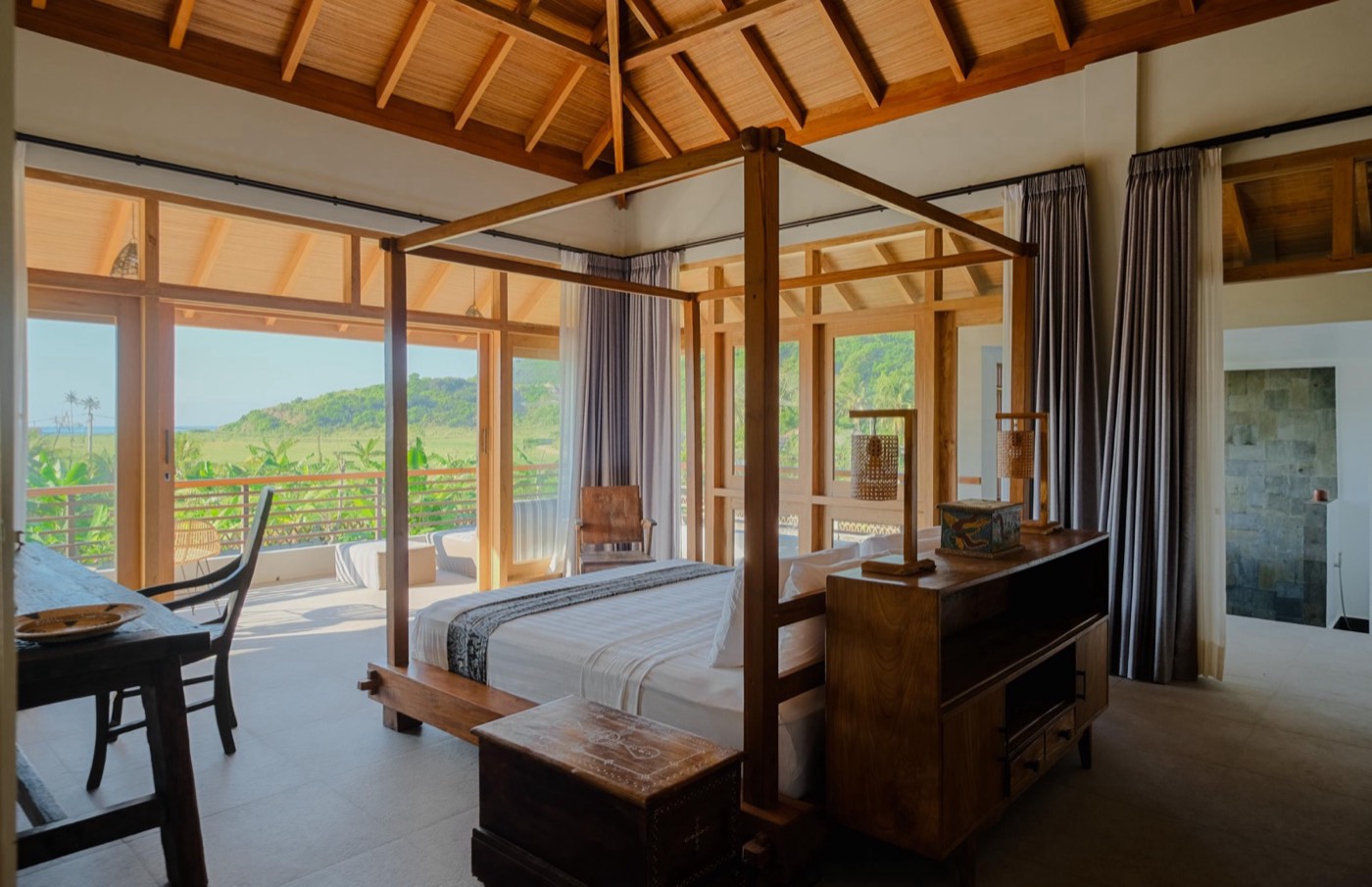 a bedroom with a four poster bed and a writing desk